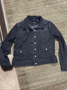 Black denim jacket with animal print on shoulder and collar.